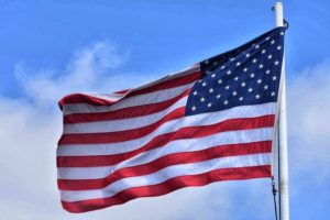 United States Flag flying in blue sky, Veterans Day Celebration at Lincoln Theatre