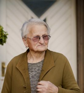 woman in brown coat wearing eyeglasses