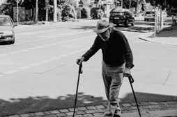 Dementia and Wandering: man with walking sticks on a path.