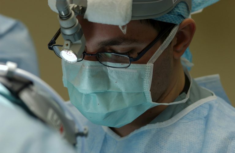 Prostate cancer screening: man in blue and white collared shirt wearing green face mask